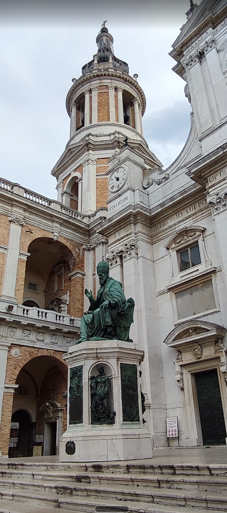 Vanvitelli's bell tower and the bronze monument to Pope Sixtus V at the Loreto basilica