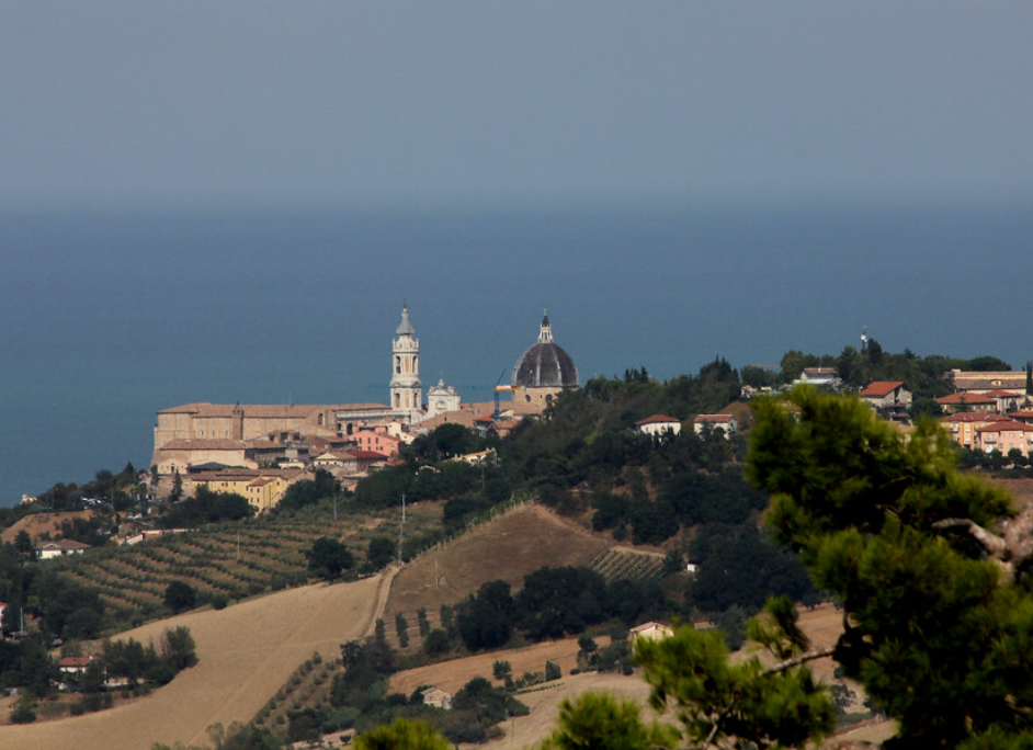 Basilica della Santa Casa dome and bell tower seen from the Marche hills above the Adriatic coast