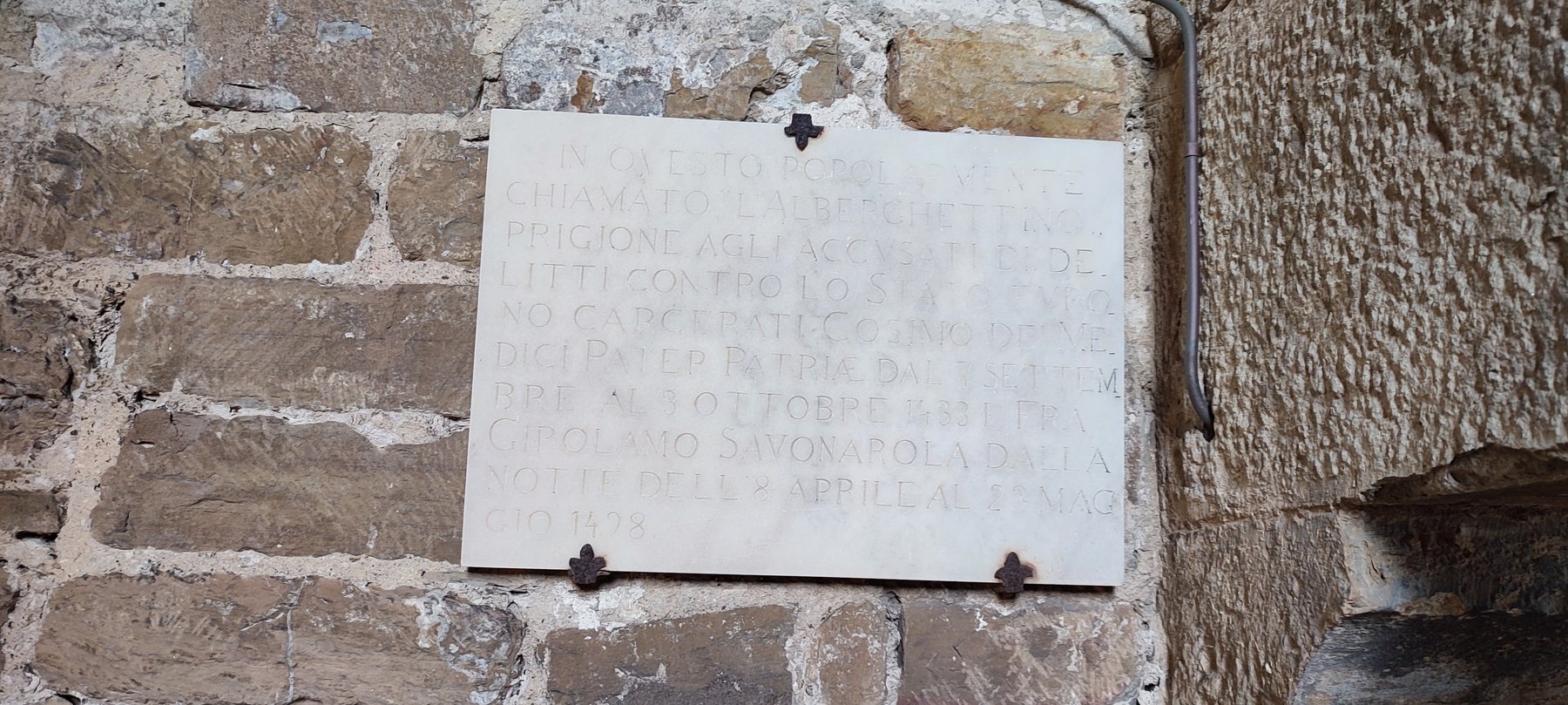 Marble plaque in the Arnolfo Tower recording the imprisonment of Cosimo de Medici and Savonarola