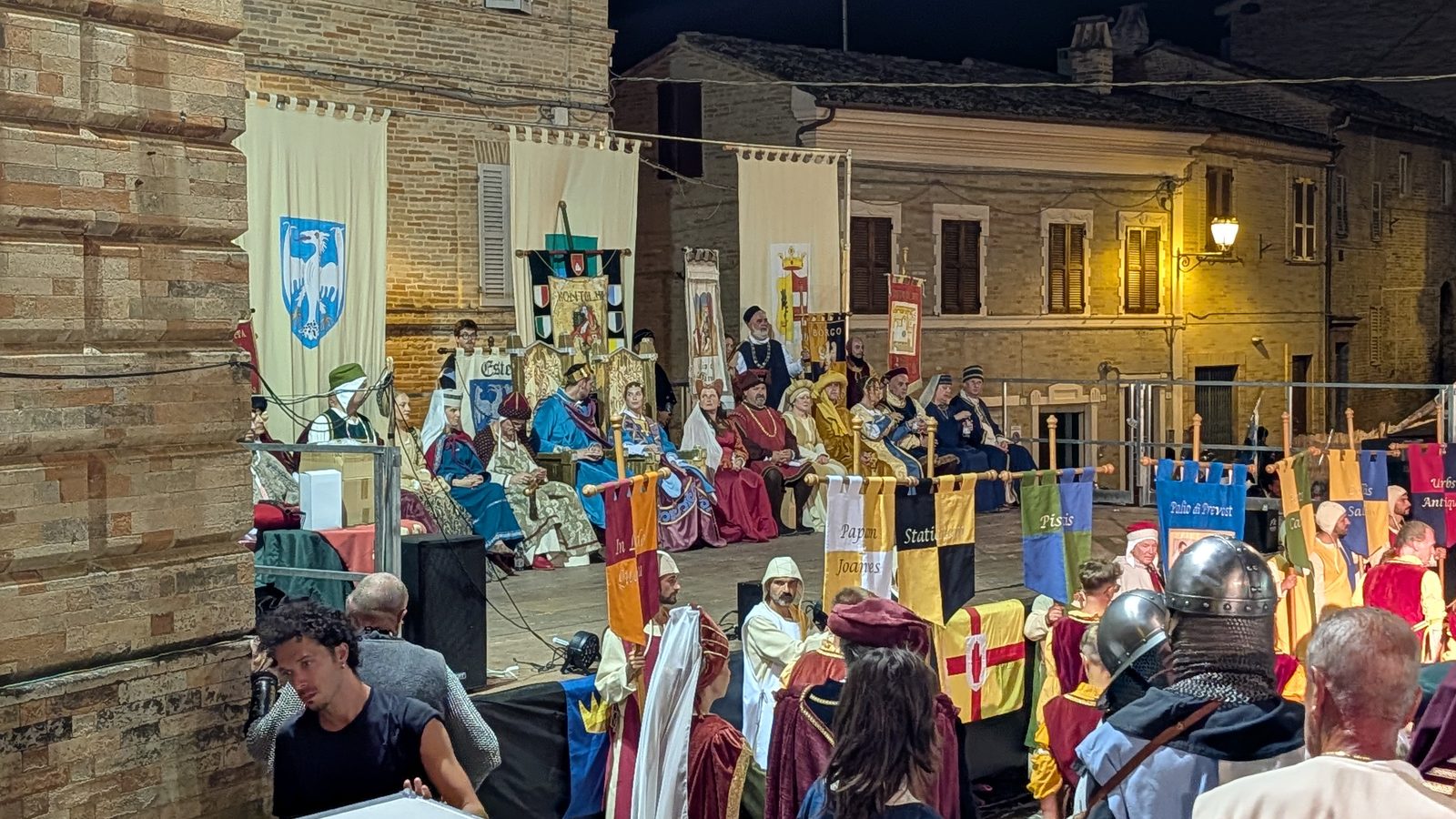 Costumed nobles seated in the tribune with delegation banners at I Giorni di Azzolino, Grottazzolina