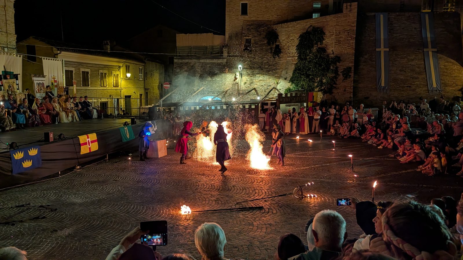Fire performers of the Focolieri di Este lighting the main piazza during I Giorni di Azzolino in Grottazzolina, Le Marche