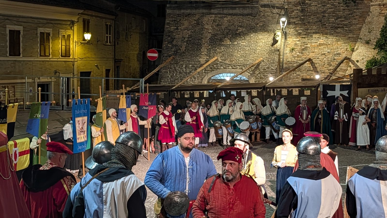Drummers, standard-bearers and men in mail forming up for the night procession at I Giorni di Azzolino
