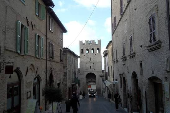 Narrow street leading to a fortified gate tower in Montefalco, Umbria