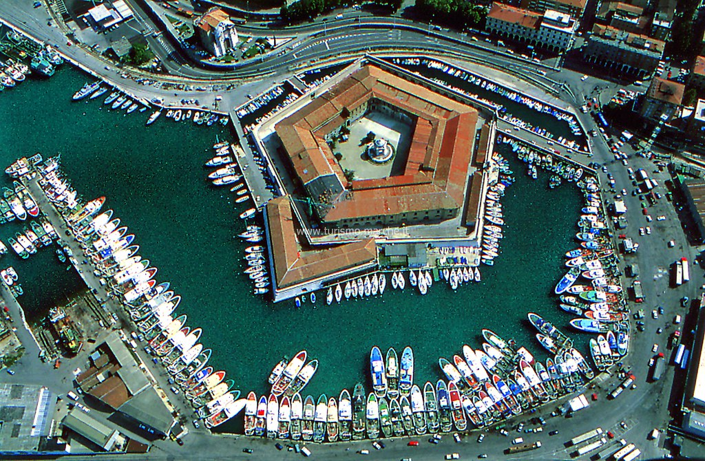 Aerial view of the pentagonal Mole Vanvitelliana surrounded by fishing boats in Ancona harbor, Le Marche