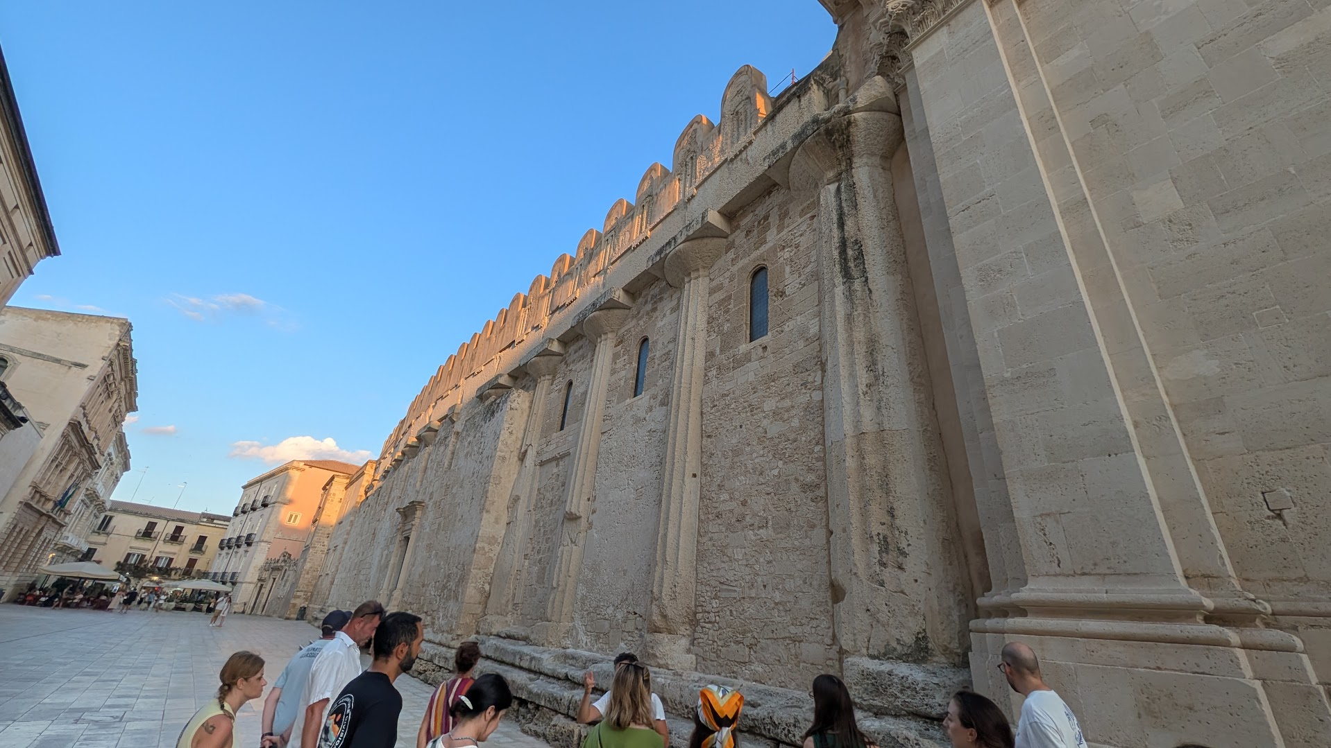 The fortress-like side wall of Syracuse's Duomo in Ortigia, built around the columns of an ancient Greek temple