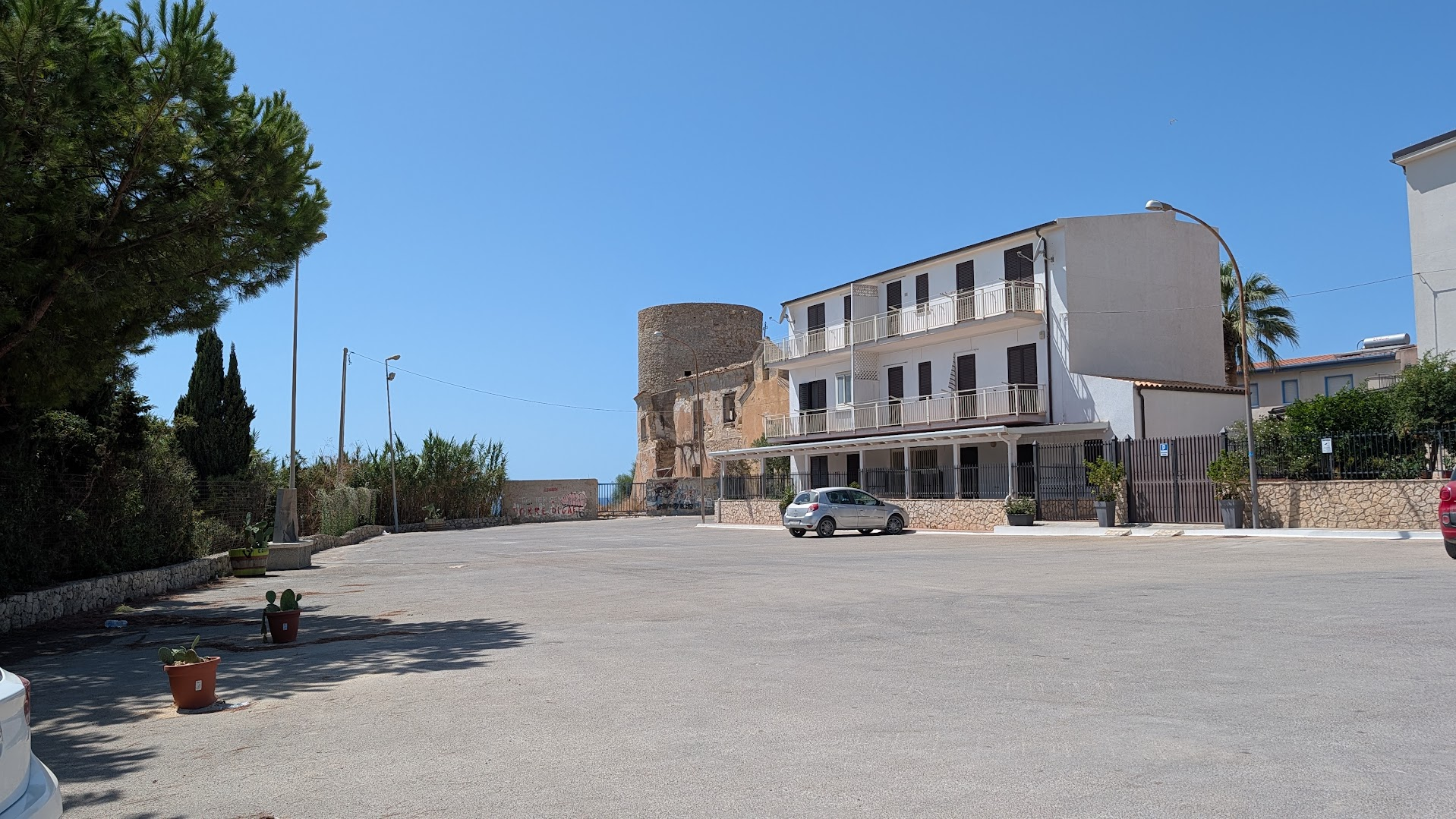 Torre di Gaffe, a sixteenth-century Sicilian watchtower, seen across a gravel parking lot at Licata