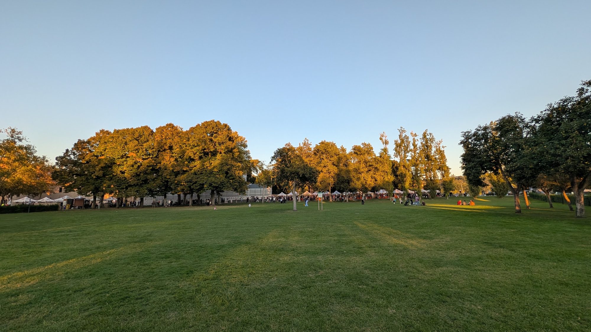 Golden hour light over the lawn at the Abbazia di Fiastra during a local gathering